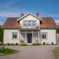 a white house with a balcony on top of it at Råshults Gård, Vimmerby