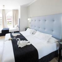 a bedroom with a large bed with swans on it at Hotel Toboso Chaparil, Nerja