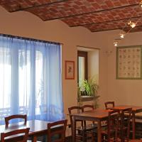 a dining room with tables and chairs and a window at La Volpe E L'uva, Cherasco