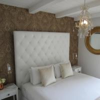 a bedroom with a white bed and a mirror at Orewa Beachcomber