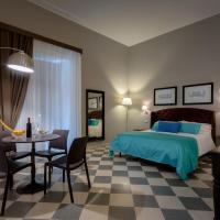 a bedroom with a bed and a table and chairs at Hotel Moderno, Trapani