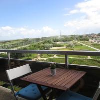 a table and chairs on a balcony with a view at Studio with sea view and panoramic view in Bredene