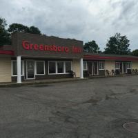 a gas station with a greenzone inn on the street at The Greensboro Inn, New Minas