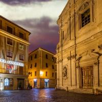 a city street at night with two buildings at Colonna Hotel, Frascati