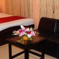 a bedroom with a bed and a chair and a table at Hotel Swiss Garden International, Chittagong