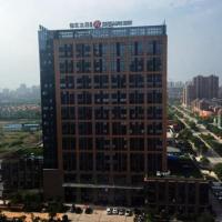 a tall building with a sign on the top of it at Jinjiang Inn Select Jiaxing Wanda Plaza
