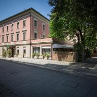 an empty street in front of a pink building at Hotel Spessotto, Portogruaro