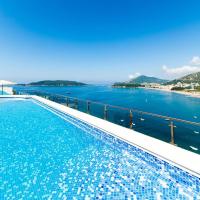 a swimming pool with a view of the water at Hotel Ponta Nova, Budva