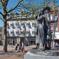 a statue of a man standing on a street at Hotel Lion D'Or, Haarlem
