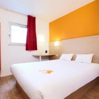 a bedroom with a large white bed and a red door at Premiere Classe Le Havre Centre-LES DOCKS