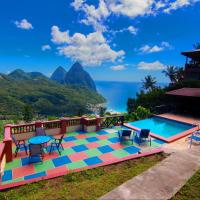 a pool with a view of the ocean and mountains at Samfi Gardens, Soufrière