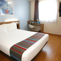 a bedroom with a large white bed with a window at Travelodge Barcelona Poblenou