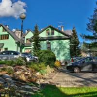 a house with cars parked in front of it at Hotel Wiosna, Rabka-Zdr&oacute;j