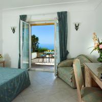 a bedroom with a bed and a couch and a table at Da Gelsomina, Anacapri