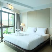 a bedroom with a white bed and a large window at A Plus Deluxe Hotel, Ko Lipe