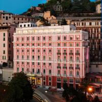 a large pink building on a city street at Grand Hotel Savoia, Genoa