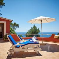 a pair of chairs and an umbrella on a patio at Las Escaleras - Pablo 74 B, Port d'Andratx