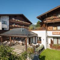 a hotel with a patio in front of a building at Hotel Haymon, Seefeld in Tirol