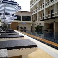 a hotel swimming pool with umbrellas in the courtyard at Phangan Pearl Villa, Haad Rin
