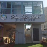 a building with a sign that reads ju la alhamptapta iidb at Sur La Mer Hotel Ashdod