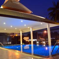 a swimming pool in a building at night at Tevan Jomtien Pattaya, Jomtien Beach