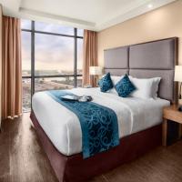 a bedroom with a large bed and a large window at Golden Phoenix Hotel - Manila
