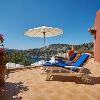 a patio with a lounge chair and an umbrella at Las Escaleras - Miguel 72 C, Port d'Andratx