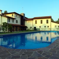a swimming pool in front of some buildings at Ca' Dei Molini, Gruaro
