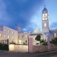 a large building with a clock tower at night at Abrahams Herberge, Bethlehem