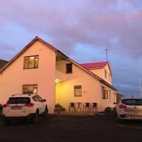 a house with two cars parked in front of it at Öndólfsstaðir Farm B&B, Laugar
