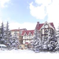 a large building with a clock on it in the snow at Rosenheim Hakuba