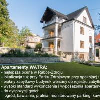 a white house with a sign in front of it at Apartamenty Watra, Rabka-Zdr&oacute;j