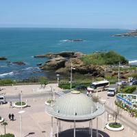 a view of the ocean from a city with a bus at Hôtel Florida, Biarritz