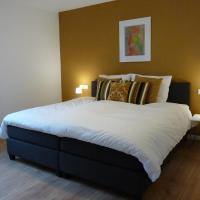 a bedroom with a large bed with pillows at Bonum Bono Suites, Laudesfeld