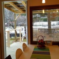 a dining room with a table and a large window at Naantali Holiday Home