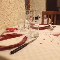 a table with a white table cloth with wine glasses at La Tana del Ghiro, Porto Valtravaglia
