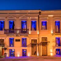a white building with blue lights on it at Maison Grecque Hotel Extraordinaire, Patra
