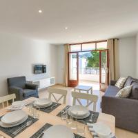 a dining room and living room with a table and chairs at Bagari Apartments Camp de Mar