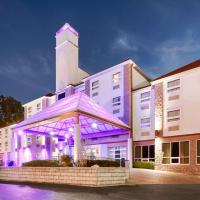 a building with purple lighting in front of a tower at Best Western Plus Sandusky Hotel & Suites