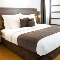 a bedroom with a large bed with white sheets and pillows at Hotel Carretero, Manizales