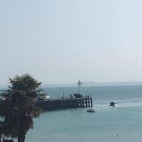 a dock in the ocean with a boat in the water at Le Cancalais, Cancale