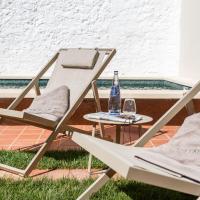 two chairs and a table with a bottle of water at Bordoy Casa Ládico - Hotel Boutique Adults Only, Mahón