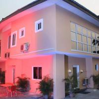 a pink house with a table in front of it at Chantella Suites, Ikeja