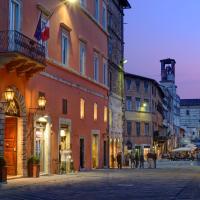 a city street with buildings and people walking down a street at Locanda della Posta Boutique Hotel, Perugia