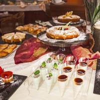 a table filled with different types of pastries and desserts at Hotel La Pace, Pisa