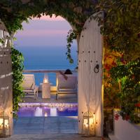 an archway leading to a pool with a view of the ocean at Athermi Suites - Adults Only, Megalochori