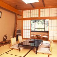 a living room with a table and chairs at Takaragawa Onsen Ousenkaku, Minakami