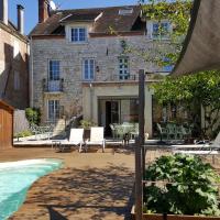 a house with a swimming pool in front of a house at Hôtel du Puy d'Alon, Souillac