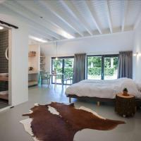 a bedroom with a bed and a room with a table at Uitgerust voor Zaken, Heerenveen