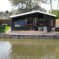 Modern chalet in a small park located right along a fishing pond